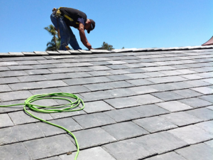 Emergency roofing team providing Gardena roof repair services for a home affected by tree fall damage.