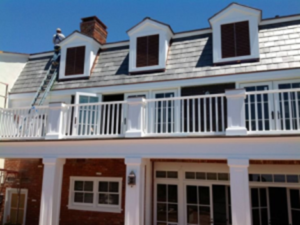 A professional roofer showcases the durability and attractiveness of modern asphalt roofing construction in Rolling Hills.